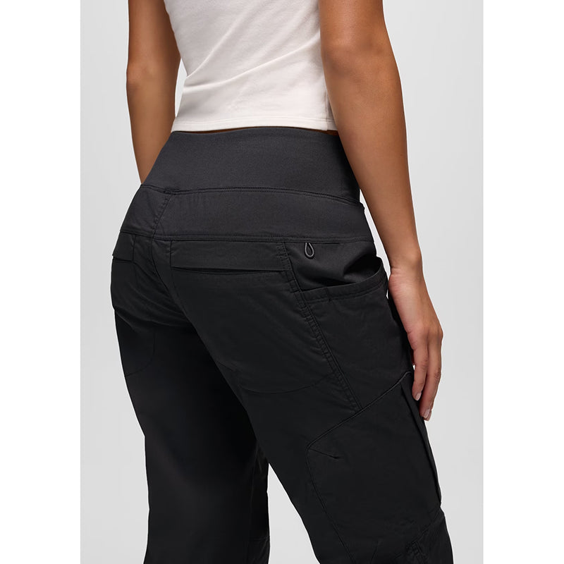 Rear three-quarter view of a person wearing dark charcoal gray technical cargo pants with a high waistband, shown against a light gray studio background.