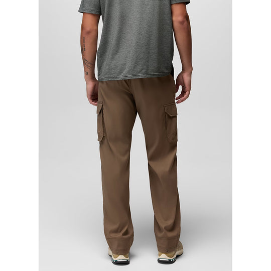 A man shown from the back wearing brown cargo pants, a heather gray t-shirt, and sneakers, photographed against a light gray studio background.