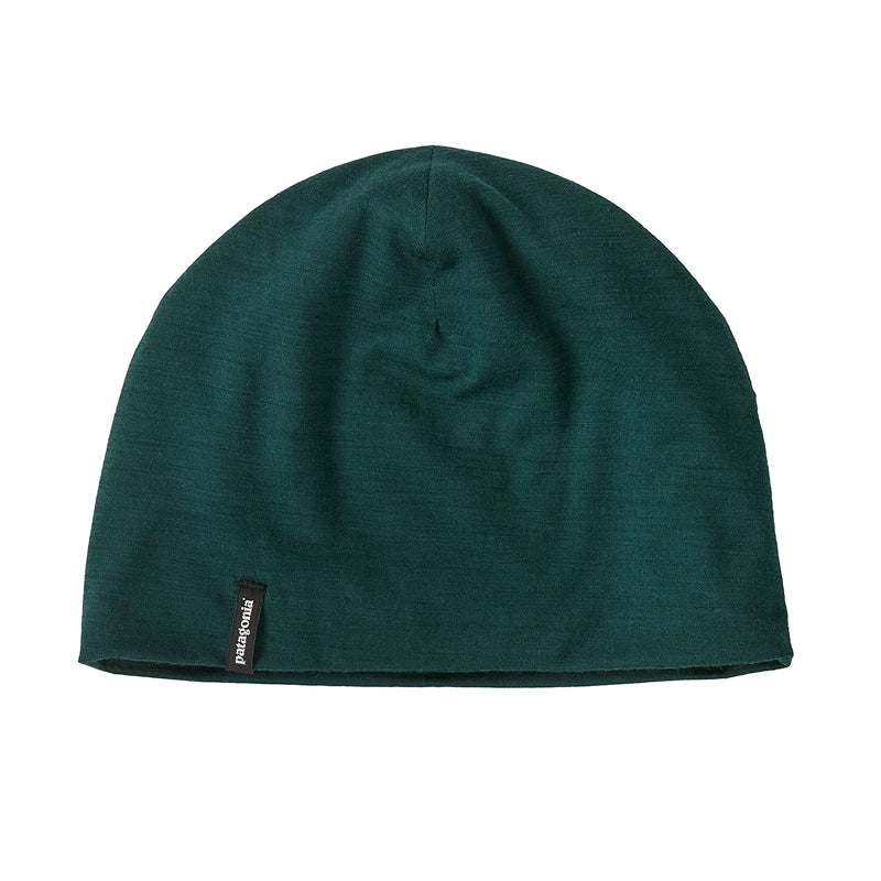 Green beanie hat with a brand label on a white background