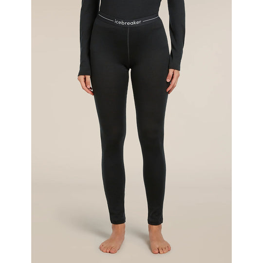 A model wearing black full-length compression leggings with a white waistband that reads &