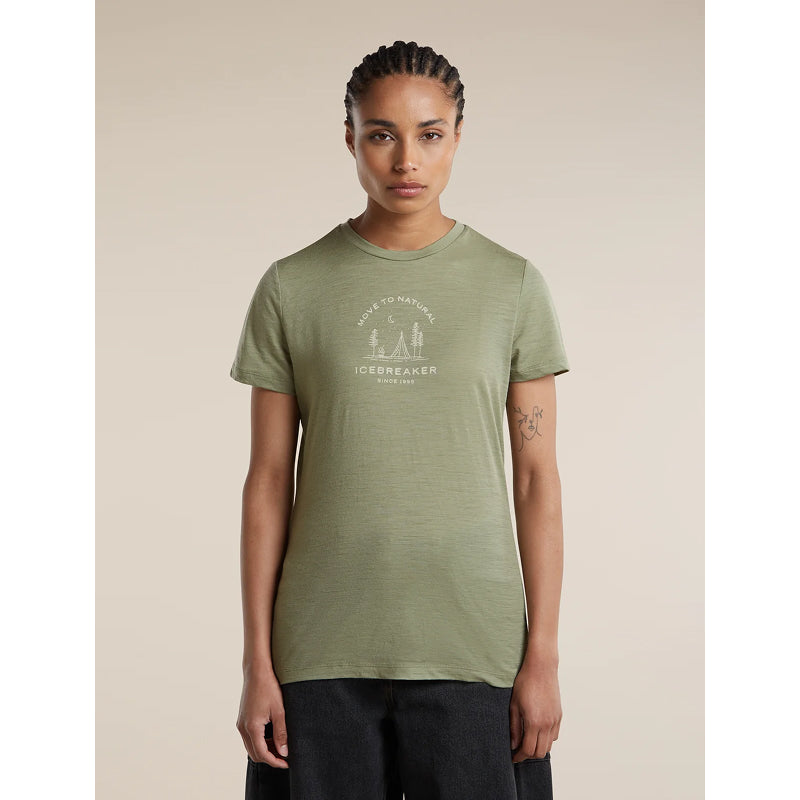 A woman modeling a short-sleeve crewneck t-shirt in sage green with a white graphic print on the chest that reads 'WATER TO NATURE ICHNEBAKER'.