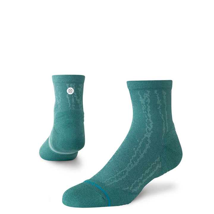 Pair of teal socks with a subtle pattern on a white background