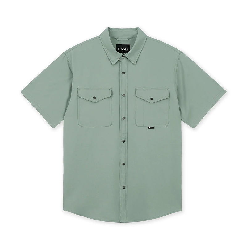 Green short-sleeve shirt with two front pockets on a white background