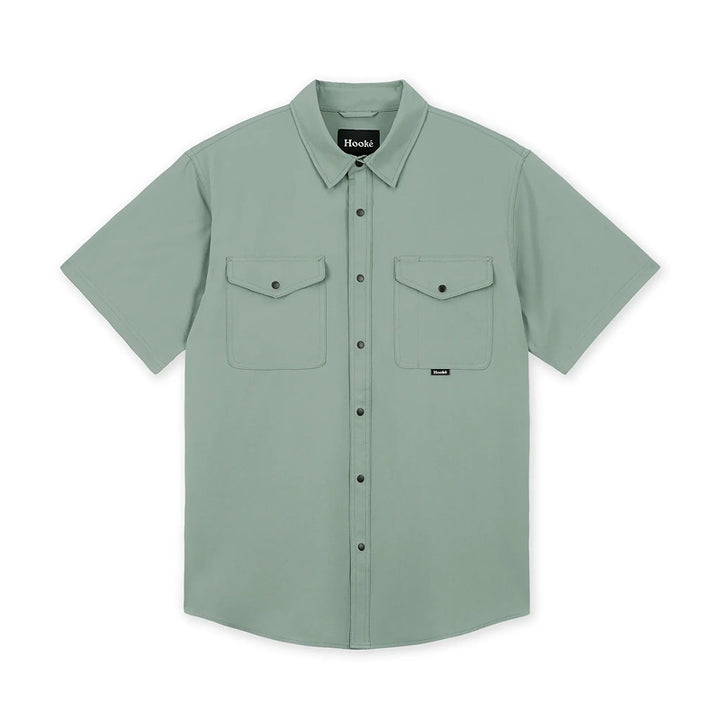 Green short-sleeve shirt with two front pockets on a white background