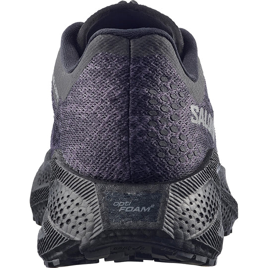 Close-up of a Salomon running shoe with sole and texture details on a white background