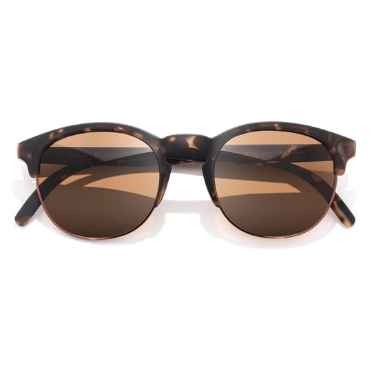 Sunglasses with tortoiseshell frame and brown lenses on a white background