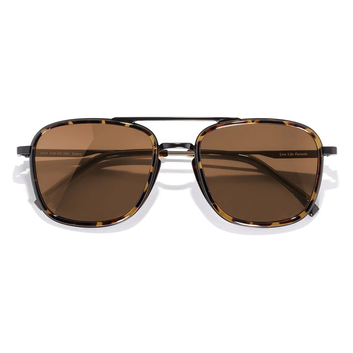 Sunglasses with brown lenses and gold frame on a white background