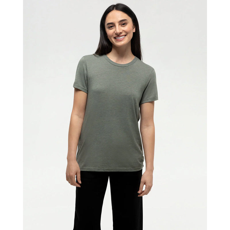 Woman wearing a green t-shirt and black pants on a white background